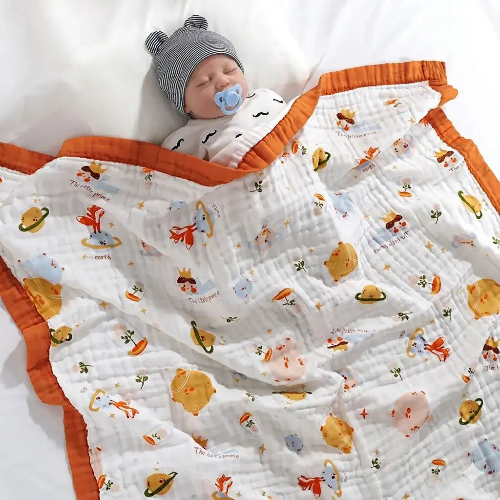 Couverture bébé en gaze de coton blanche motifs espace avec bordure orange